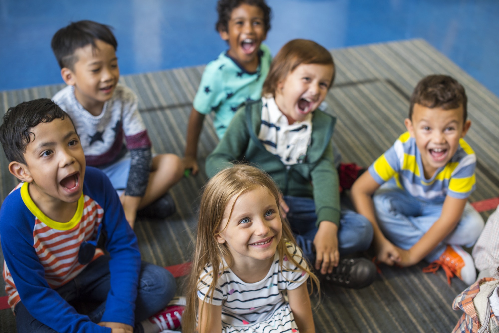 Kindergarten students sitting on the floor