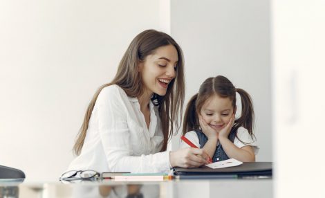 Tutor with litthe girl studying at home
